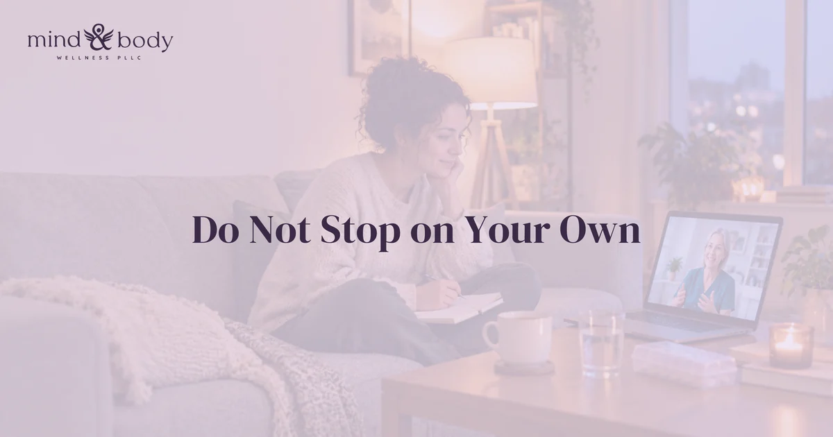 Woman on a couch with a notebook attending a video visit with a provider on her laptop